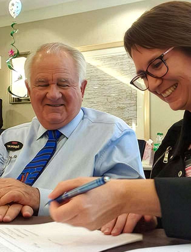 Josephien signing her franchise agreement with Dr. Spencer Kagan