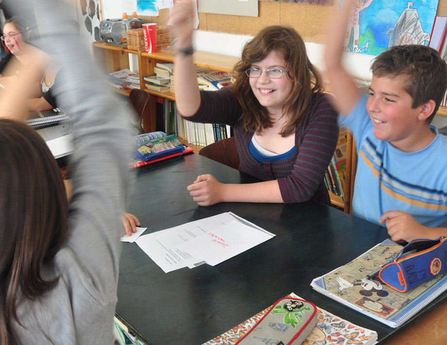 Teacher and student giving a high five in the classroom